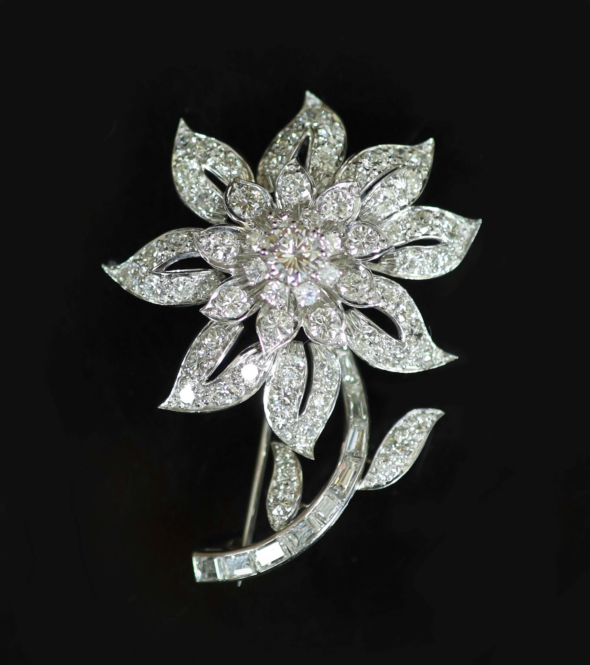A white gold and diamond encrusted flower brooch